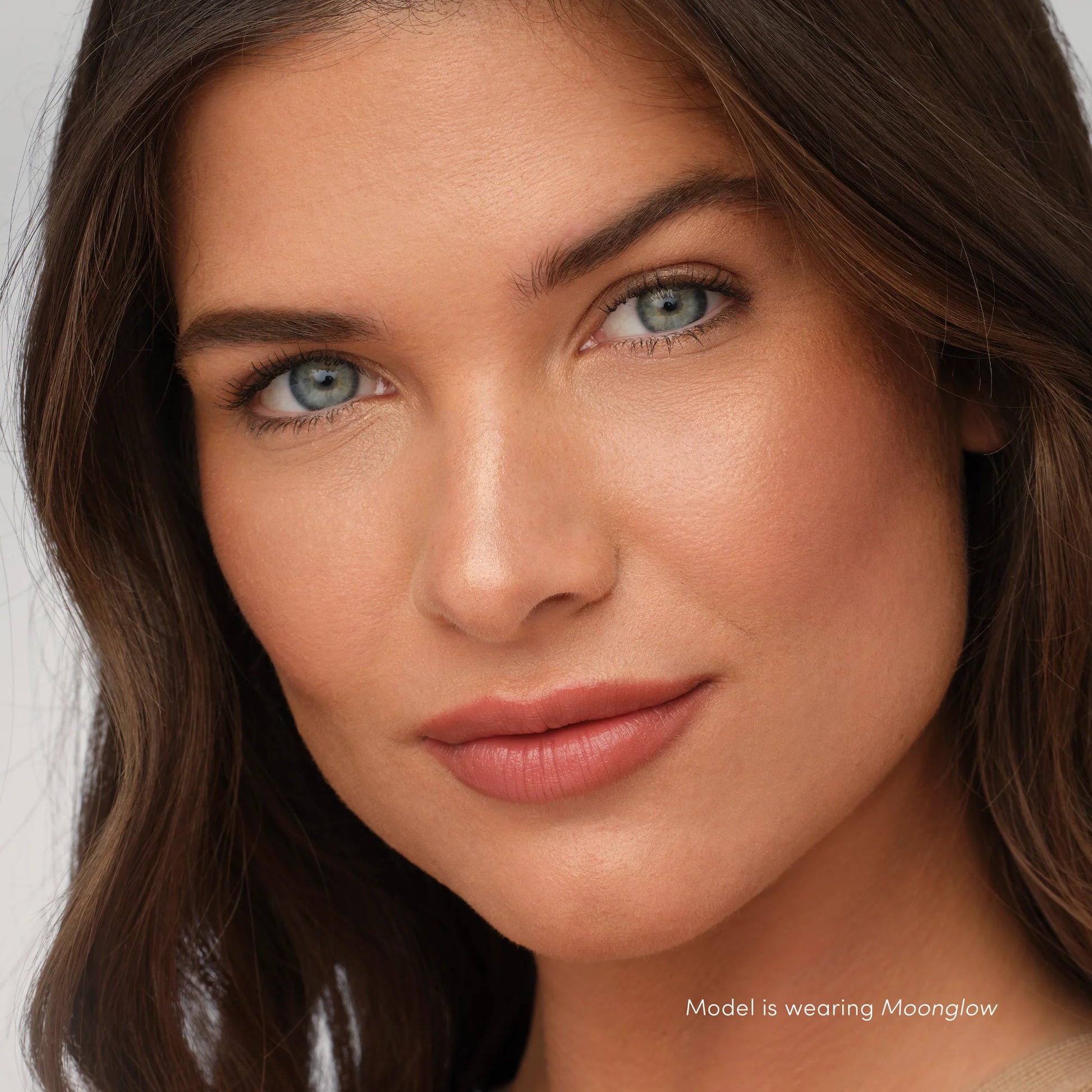 Close-up of a woman wearing Moonglow from PureBronze™ Shimmer Bronzer Palette, highlighting radiant skin with a brilliant shimmer.