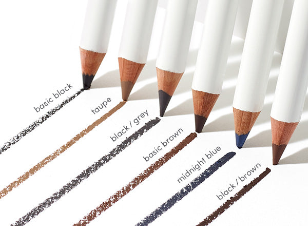 Six white-barreled Eye Pencils with color swatches underneath, showcasing shades from black to blue, designed for smooth, irritation-free application and long-lasting wear.