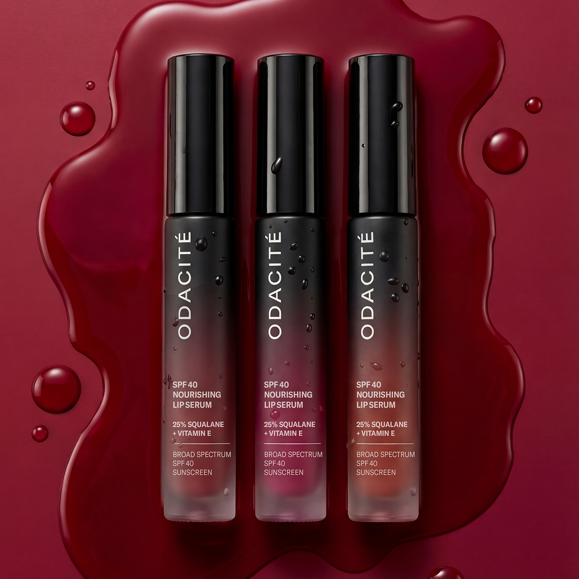 Odacité SPF 40 Nourishing Lip Serum tubes showcasing broad-spectrum protection and hydration, arranged on a glossy red background.