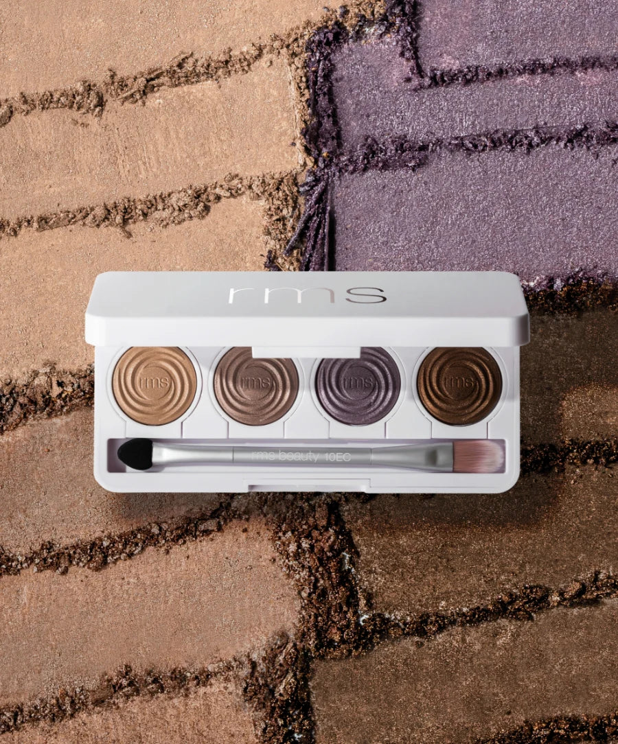 ReDimension Hydra Eyes Quartet by rms: A white compact with four creamy‐powder shadows and dual-ended applicator, showcasing warm neutrals and muted violet swatches.