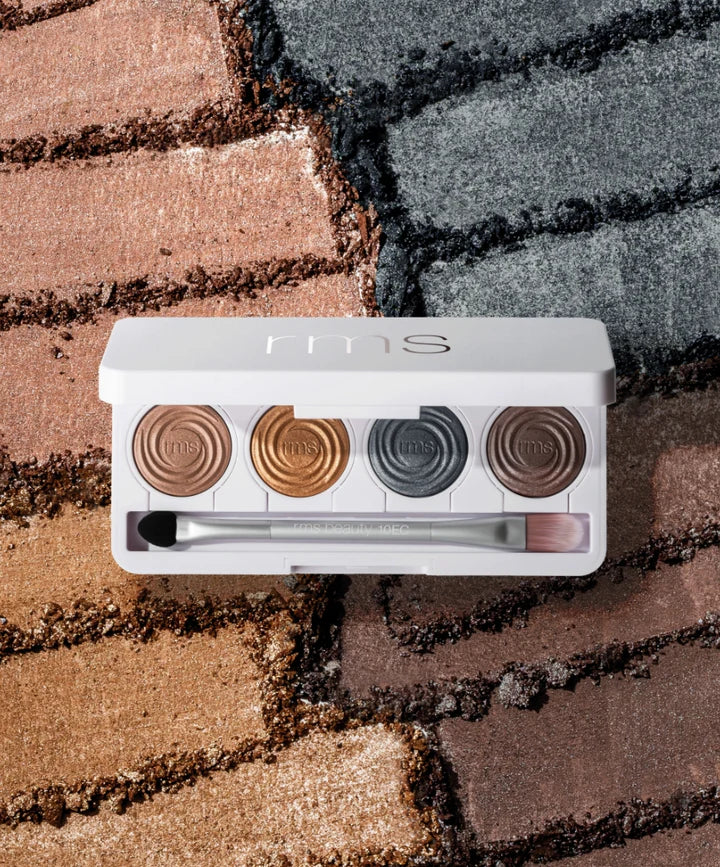 RMS Beauty ReDimension Hydra Eyes Quartet: five warm metallic neutral eyeshadows in a white compact, with a dual-ended brush, shown swatched for texture.