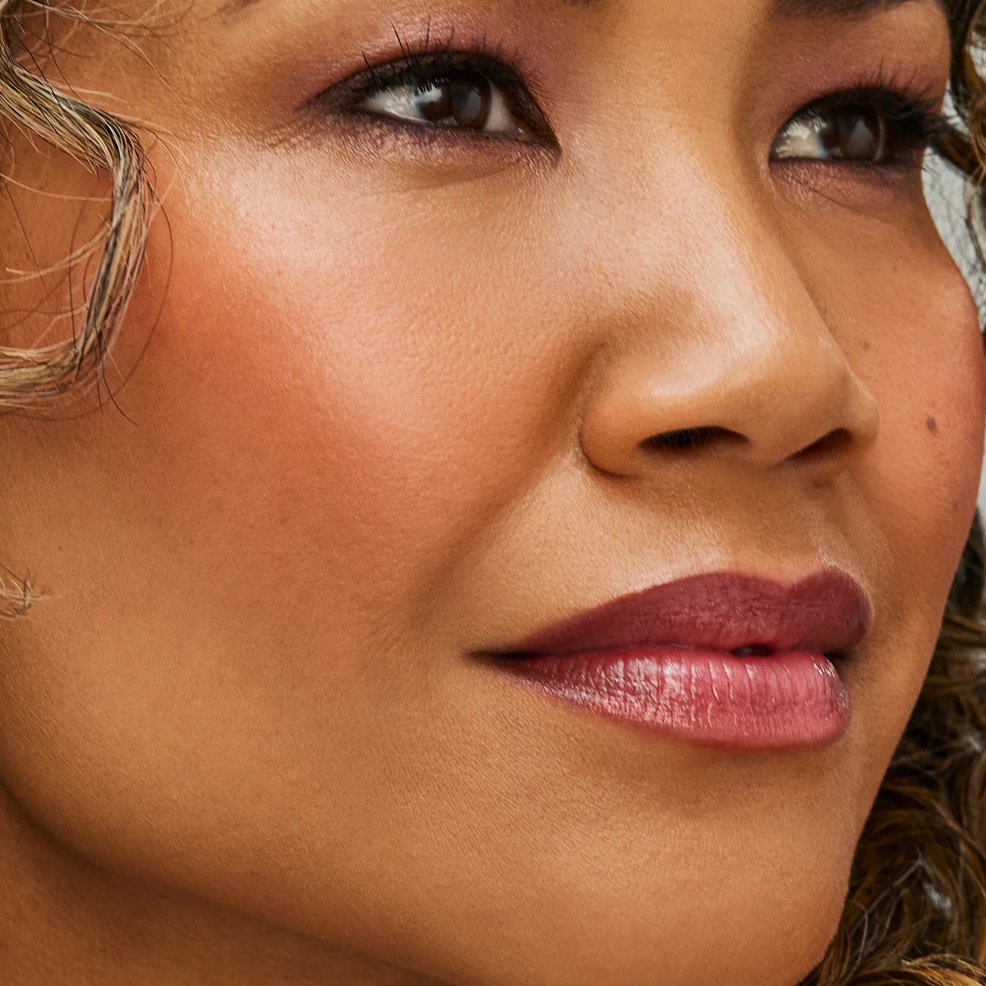 Close-up of a face with makeup, showcasing smooth skin using Glow Time® Bronzer Stick for a natural, sun-kissed glow.